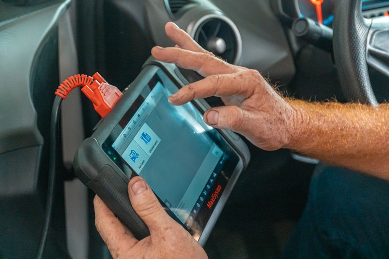 Mechanic running diagnostics on a car engine