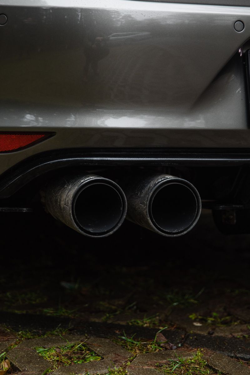 Muffler and exhaust system under a vehicle